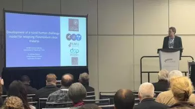 A Photo of Andrew Duncan presenting on stage.